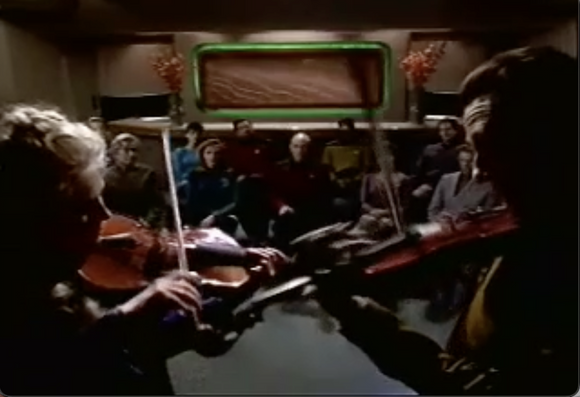 In Ten Forward Data and the widow of his creator play violins in concert.