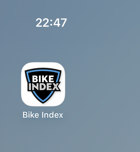 The Bike Index iOS app icon on the iOS home screen with the time 22:47 visible. The icon has a white background containing a black shield with the white text "Bike Index" and a thin blue border inside the shield (and interrupted by the text).