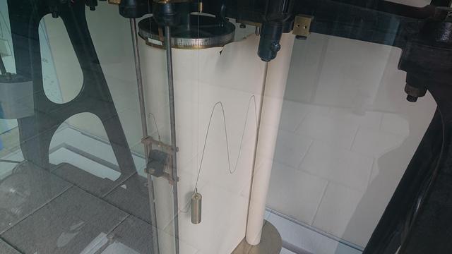 The output stage of the machine.  The end of the wire that wends round the pulleys is attached to a pen mechanism that draws a varying amplitude sine wave onto a scroll of paper