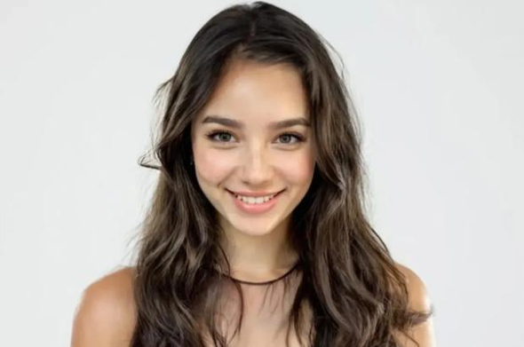 The image features a person with long, wavy, dark brown hair, wearing a sleeveless top with a sheer neckline. The background is a plain, light gray color, providing a neutral backdrop that highlights the subject. The person is positioned centrally in the frame, with their shoulders visible, suggesting a portrait-style photograph. The lighting is soft and even, illuminating the subject's hair and top without creating harsh shadows. The overall composition is simple and focused, drawing attention to the individual's hairstyle and attire.

Provided by @altbot, generated privately and locally using Ovis2-8B