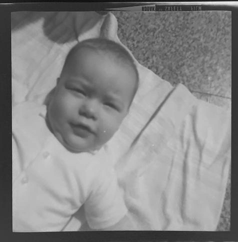 Black and white image of me as an infant, head and shoulders shot, kind of diagonally from the lower left corner.