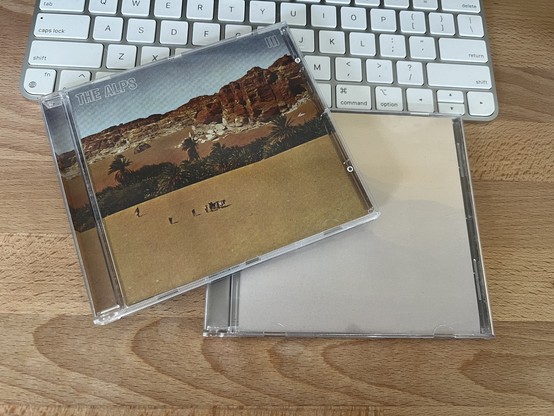 A photo of the CD covers for “III” (2008) and “Le Voyage” (2010), both depicting sweeping landscapes which matches the mood of their music.