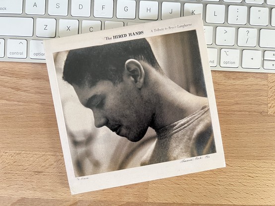 A photo of CD for “The Hired Hands: A Tribute to Bruce Langhorne” features a black-and-white side profile portrait of Bruce.