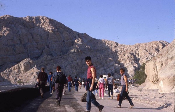 A color photo of people walking towards the concert area for the Desolation Center event.