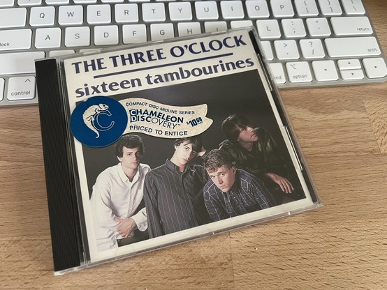 A photo of the album cover for “Sixteen Tambourines” by The Three O’Clock features a typical 80s band promo photo with the title in very large ITC Benguiat for the font nerds.