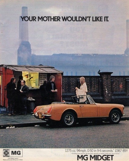 An advert for an MG Midget in 1972 . It’s an overcast day somewhere in England where there are still giant smokestacks. There’s an orange convertible parked on the street with a man and woman standing in line for some fish and chips. The caption reads: “Your Mother Wouldn’t Like It”