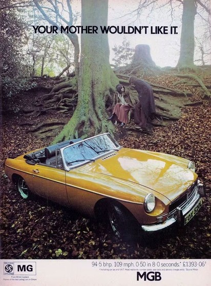 Like an album cover, but it’s an advert for an MGB in 1972. It’s an overcast day. There’s a man and a woman sat at the foot of a tree with giant roots somewhere in a forest. In the foreground is a yellow convertible. The caption reads: “Your Mother Wouldn’t Like It”