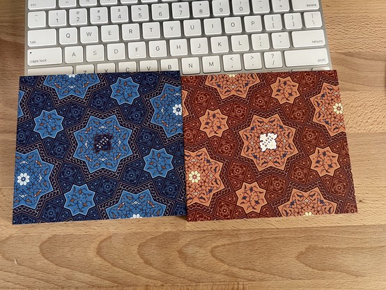 Two CD digipacks for Klaus Wiese’s “Qumra I” and “Qumra II”, originally released on cassette in the 1980s, featuring Middle Eastern interlocking patterns. One is in blue, the other burnt orange.