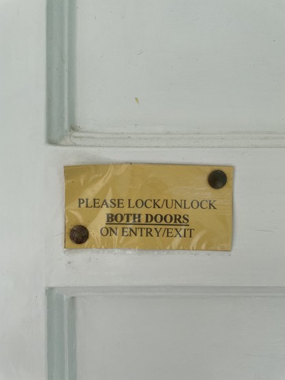 Note on door reads PLEASE LOCK/UNLOCK BOTH DOORS ON ENTRY/EXIT