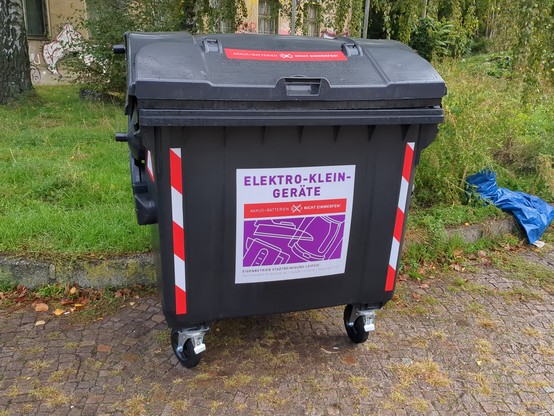 Big black bin with red and white 