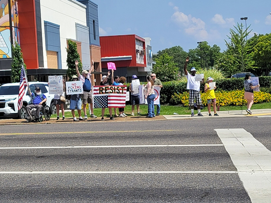Protestors at Poplar and Highland, Memphis, Tennessee, July 4th 2025. I'm the one with the "NO FCKING TYRANTS" sign. Photo via tlyns-boyfriend @ bluesky.