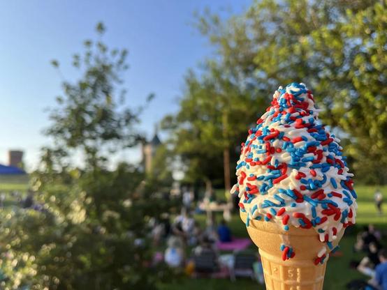 “A sparkly sweet treat for a sparkly sweet mix.” A close-up photo of vanilla soft-serve with red, white, and blue sprinkles in a sugar cone. 📸 by Lars Gotrich/NPR