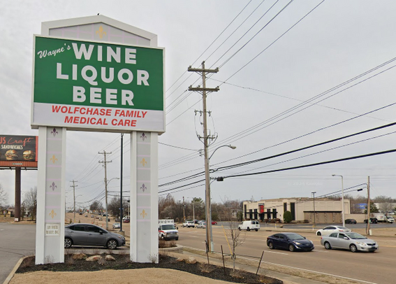 A sign outside of a commercial complex in Memphis, Tennessee. The top 3/4 of the sign has a green background and white text, and is devoted to "Wayne's WINE LIQUOR BEER." The bottom 1/4 of the sign, with a white background and red text, says "WOLFCHASE FAMILY MEDICAL CARE." Taken in all at once, it looks like the liquor store may also be the family medical care center.