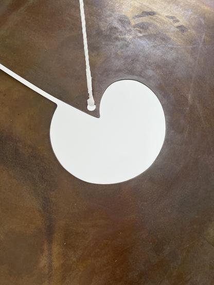 Closeup of another (I think) untitled Sonambient instrument/sculpture. It looks like a squarish, oversized cymbal with an unusual opening in the center that appears to be slit down the side.