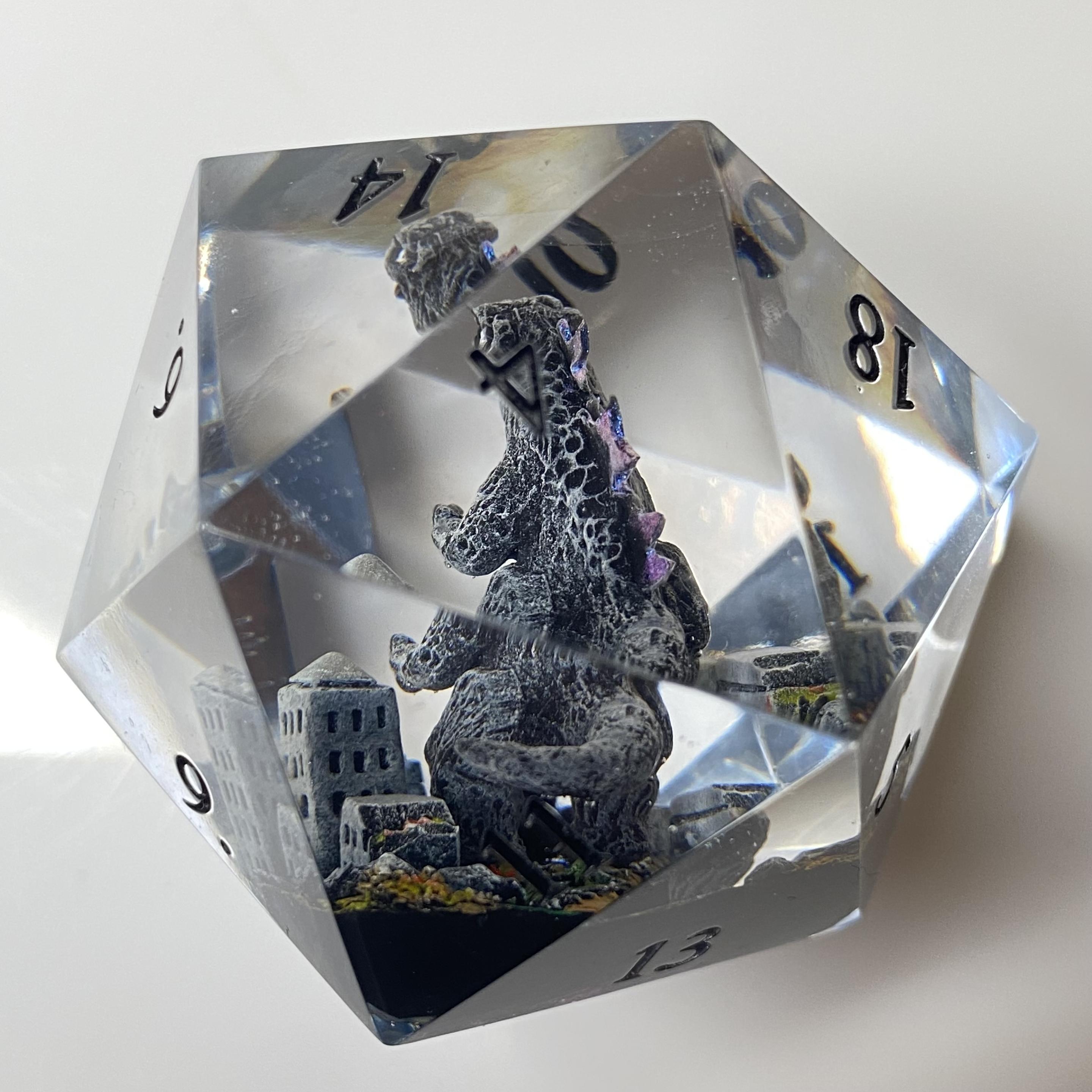 Behind Godzilla, you can see his curled tail and the burning rubble in his wake!