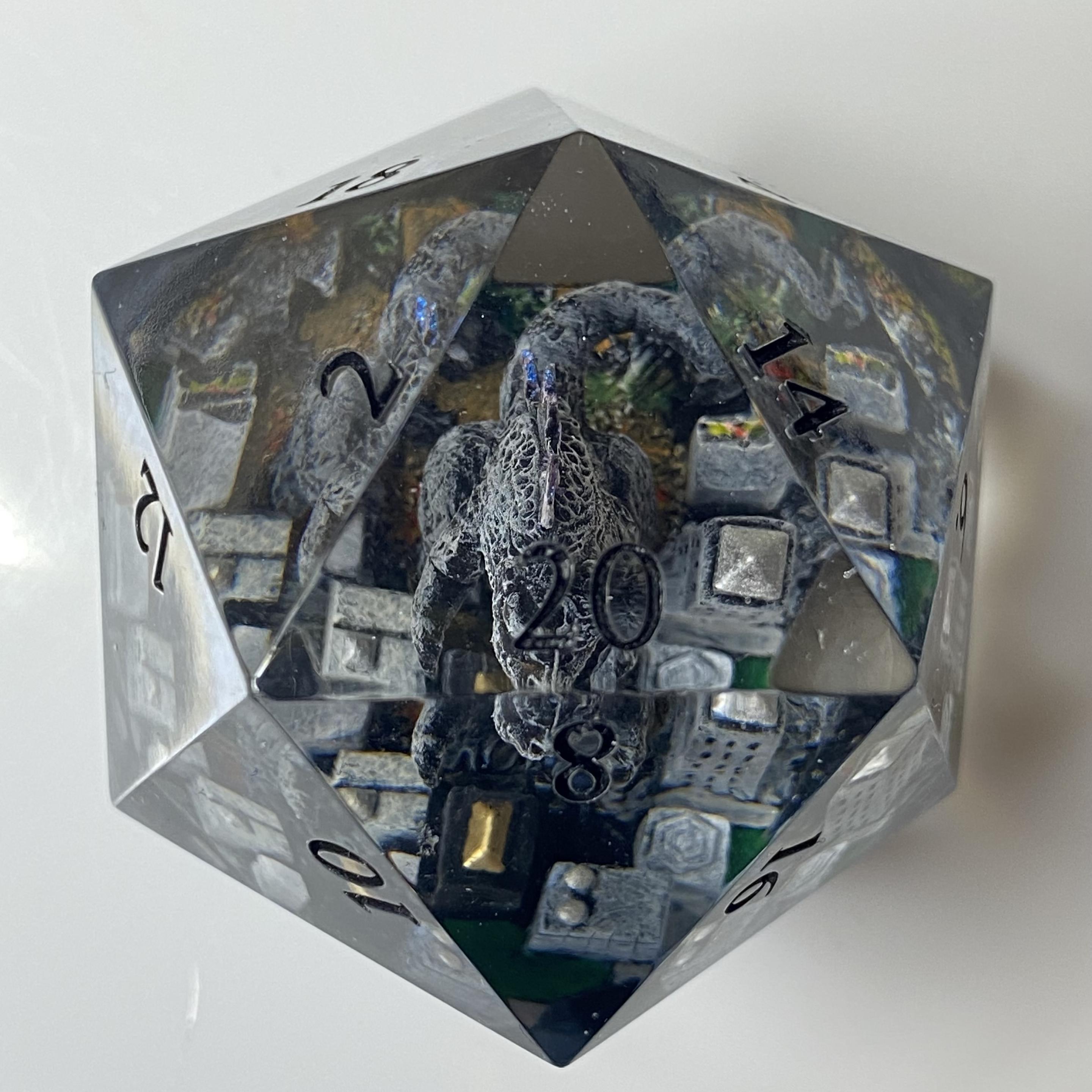 Overhead, Godzilla is very bumpy and grey, with just a hint of blue iridescence on his back spines, for nuclear power. The city is mostly white and grey buildings, with some beige, silver and gold. There are streets and grassy areas that he hasn't destroyed yet, and mud and chunks of buildings where he has