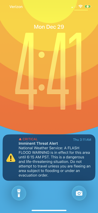 Lock screen with an expired flood alert from LAST week.