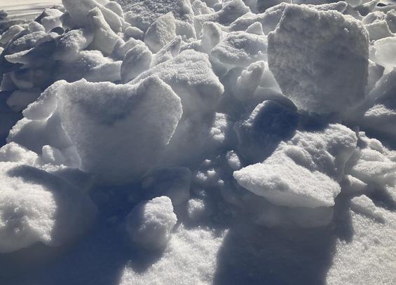 The Antarctic surface glistens in brilliant white -- oh, no, that's not right. An accretion of sleet and ice coats the ground in Memphis, Tennessee, January 28, 2026. Large chunks, pickaxed from a giant drift, are perched atop a base layer. The sun casts shadows from the ice.