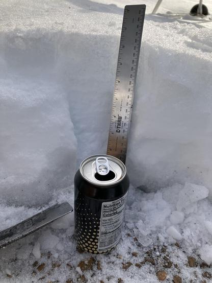 Memphis, Tennessee, February 1st 2026. A sheet of ice from a storm _last_ weekend sits atop a driveway. A soda can and a ruler measuring around 10” provide some scale.