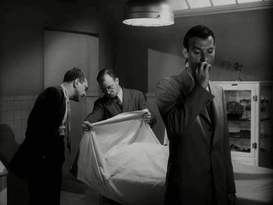 Max Thursday (Zachary Scott) looks away as the morgue doctor lifts a sheet to show Captain Tonetti (Sam Levine) the murder victim.