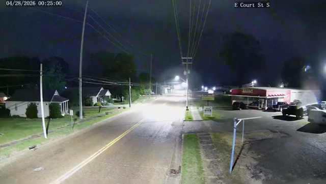 A tornado touches down in Dyersburg, Tennessee, just after midnight on Tuesday, April 28. Video: Dyersburg Police Department. A rural street is visible with small buildings on both sides. A tornado appears on the right side of the image and gradually moves across the street to the left.