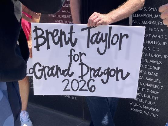 A protestor holds a sign that says “Brent Taylor for Grand Dragon 2026.” I Am A Man Plaza, Memphis, Tennessee.