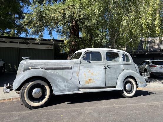 Looks like a Chrysler BUT it’s actually a 1937 or 1938 Chevy Master Deluxe, a classic four door pre-war cruiser, with suicide doors.
