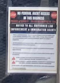 A sign in the window at the Four Way restaurant proclaims “no federal agent access in this business” because FUCK ICE 
