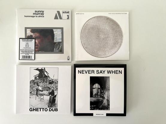 Four CD albums, from left to right:

Sunny Murray “Homage to Africa”
John Davis “The Gold Hooped Nature”
Bim Sherman “Ghetto Dub”
Various Artists “Never Say When”
