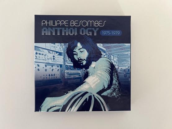 Front cover of the anthology box featuring Philippe Besombes at the controls in shades of blue.
