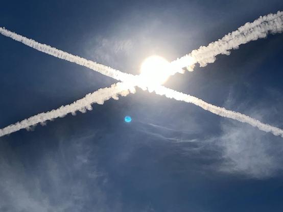 Intersecting contrails in front of the late morning sun. One of them was casting an eye-catching shadow. Memphis, Tennessee, September 20, 2026