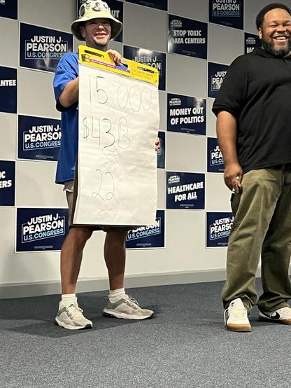 Me and Brian Manuel on stage at Justin Pearson's Road to Victory Rally in Memphis, September 21, 2026. Brian was presenting various statistics but he didn't have an easel to hold his giant easel pad, so l stood there feeling like Vanna White for a few minutes.